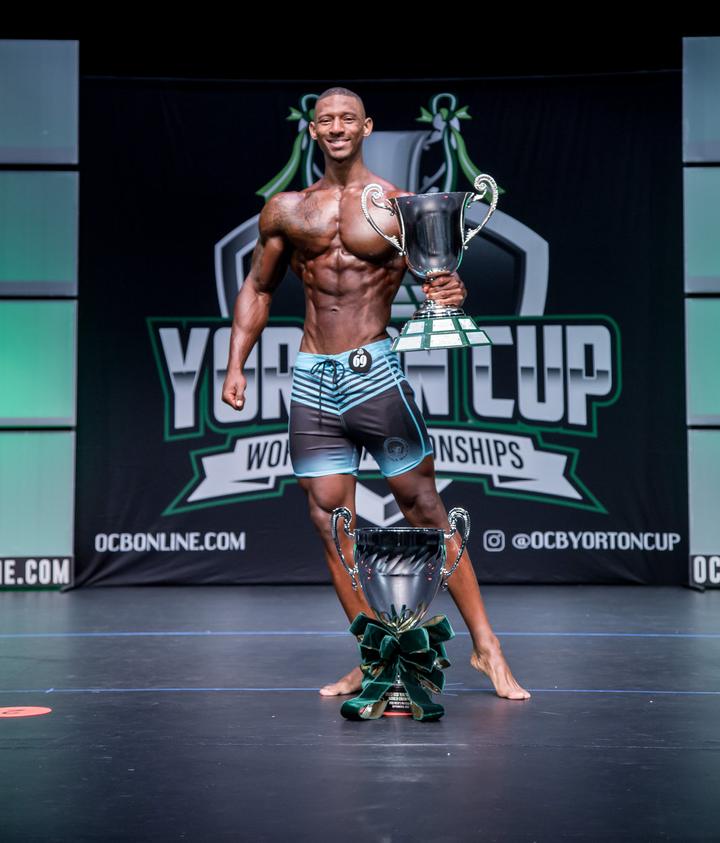 Eric Shelton on stage holding the Yorton Cup trophy